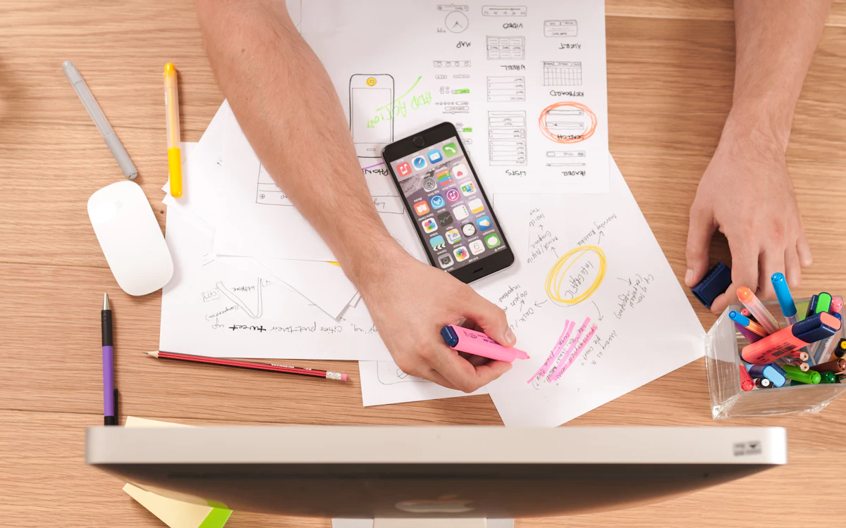Laptop on a desk showing analytics and a notebook for planning SEO